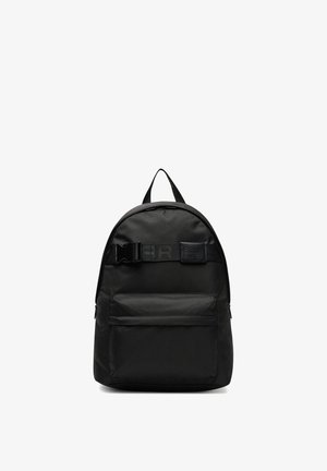 Czarny plecak z tkaniny z przednią kieszenią na zamek, górnym uchwytem oraz poziomym paskiem z plastikową klamrą z przodu.