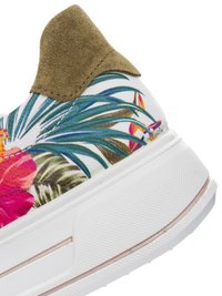 Biały sneaker z zieloną zamszową zakładką na pięcie i kolorowym tropikalnym kwiatowym wzorem po boku nad grubą teksturowaną podeszwą.