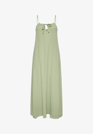 Robe maxi sans manches de couleur vert clair avec des bretelles spaghetti et un petit nœud au niveau du décolleté en forme de trou de serrure, présentant un tissu subtilement texturé.