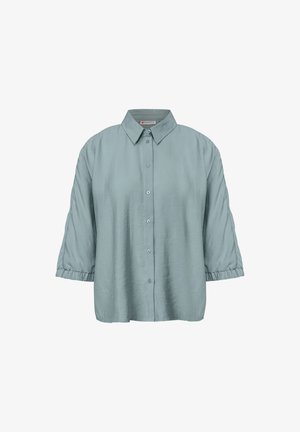 Camicia button-up azzurro chiaro con colletto, vestibilità over size e maniche a sbuffo, realizzata in tessuto testurizzato. Presenta cinque bottoni sulla parte frontale.