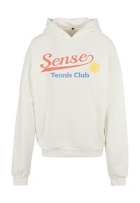 Fehér kapucnis pulóver kenguru zsebbel. A "Sense Tennis Club" felirat piros és kék színben, sárga teniszlabda grafikával. Puha anyag.