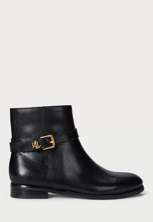 Black leather ankle boot with a low heel, featuring a buckle accent with gold hardware and stitching detail around the ankle.