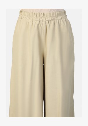 Beżowe spodnie szerokie z elastycznym paskiem, gładką fakturą i luźnym krojem, zapewniające komfort i swobodę ruchów.
