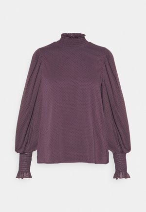 Long-sleeve purple blouse with high ruffled collar, puffed sleeves, smocked cuffs, and subtle polka dot texture.