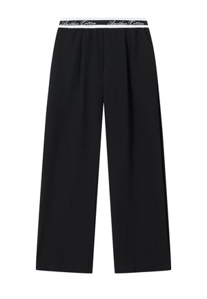 Schwarze, weit geschnittene Hose mit elastischem Bund und weißem "Another Cotton" Schriftzug als Markenzeichen.