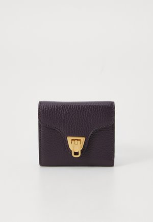 Dark purple leather wallet with a textured surface, featuring a curved flap and gold hardware clasp. Compact rectangular shape.