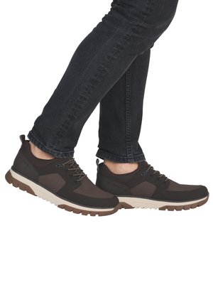 Brown athletic shoes featuring a combination of smooth and textured materials, lace closure, and a durable rubber sole with grooved tread.