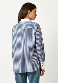 Blue and white striped shirt with a classic collar, buttoned cuffs, and a back yoke. Features a subtle pleat detail along the back.