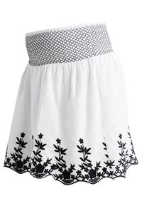 Valkoinen hame, jossa musta kirjailtu kukkakuosi helmassa. Siinä on teksturoitu musta vyötärönauha ja levenevä siluetti.