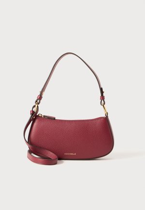 Burgundy leather handbag with a curved design, featuring a short handle and a detachable strap. Gold-tone hardware accents present.