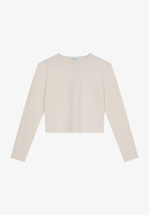 Długi rękaw krótki top w jasnym kremowym kolorze, z okrągłym dekoltem i minimalistycznym wzornictwem, z subtelnym logo na przodzie.