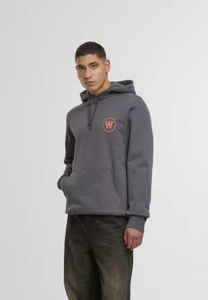 Grå hettegenser laget av bomullsblandingsstoff, med en frontlomme og en oransje sirkulær logo på brystet. Designet med hette som kan justeres med snor.
