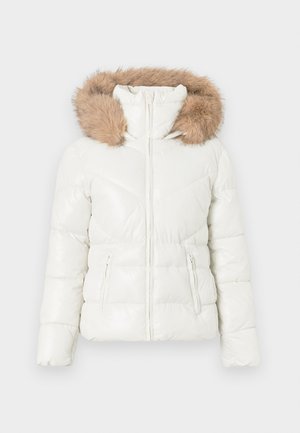 White quilted winter jacket with front zipper, side zip pockets, and a brown faux fur-trimmed hood.