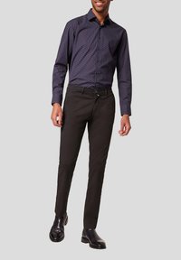 Marineblauwe overhemd met kleine witte stippen, slim-fit zwarte broek en glanzende zwarte dress boots; gladde textuur en getailleerd silhouet.