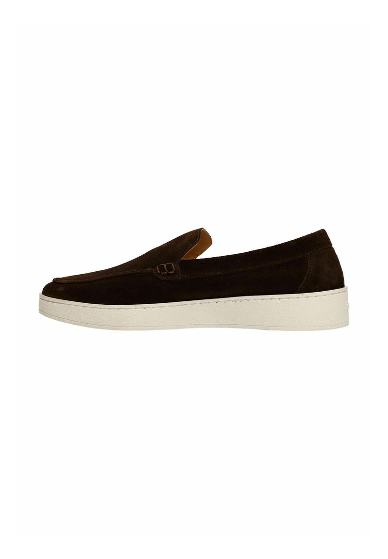 Brown suede slip-on shoe with a low profile, featuring a white rubber sole and a small decorative buckle on the side.