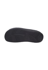 Schwarze Gummisohle mit einem Profilmuster, das Rillen und Erhebungen für Grip aufweist. Strukturierte Oberfläche mit sichtbarem Logodetail.