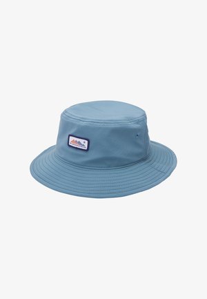 Light blue bucket hat made of soft fabric, featuring a flat top, wide brim, and a patch with mountain design on the front.