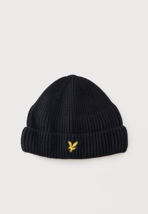 Bonnet en tricot côtelé noir avec revers, orné d’un petit logo aigle jaune brodé au centre devant.