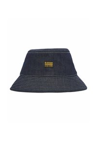 Denim bucket hat in dark blue with contrasting white stitching. Features a woven label on the front, wide brim, and rounded crown.