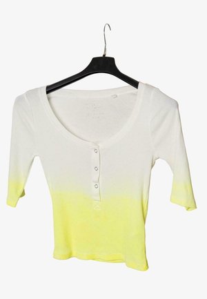 White to yellow ombre ribbed knit shirt with three front buttons and three-quarter sleeves hanging on a black hanger.