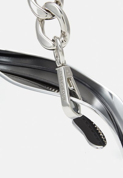 Silver metal chain link with a clasp, featuring a polished finish. Attached to a black leather-like strap with a zippered detail.