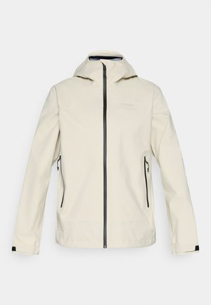 Lichtbeige waterdichte jas met een ritssluiting, verstelbare capuchon, twee zijzakken en zwarte accenten langs de ritssluiting en mouwen.