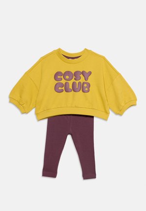 Κίτρινο cropped φούτερ με μοβ κείμενο ""COSY CLUB"" συνδυασμένο με μοβ κολάν για παιδιά.