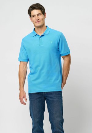 Light blue polo shirt made of cotton, featuring a collared neck and short sleeves. Plain design with a small logo on the chest.