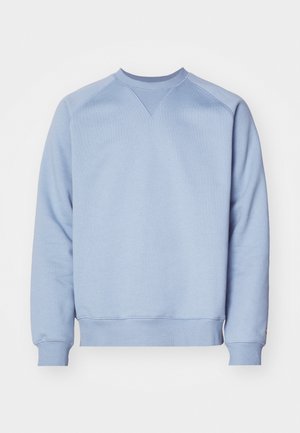 Light blue sweatshirt made of cotton blend. Features a crew neckline, ribbed cuffs, and hem, with a triangular stitch detail at the neck.