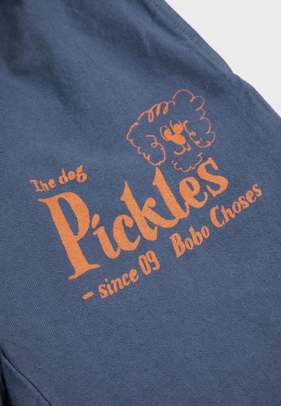 Navy fabric with orange text "Pickles" and a cartoon poodle face, accompanied by "the dog," "since 09," and "Bobo Choses" text.
