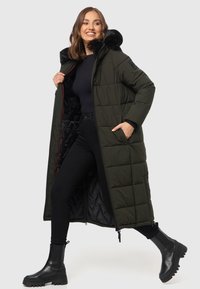 Langer, olivgrüner gepolsterter Mantel mit einer schwarzen Kunstfellkapuze, Reißverschluss vorn und seitlichen Reißverschlusstaschen. Schwarze Innenauskleidung und strukturierte Nähte.