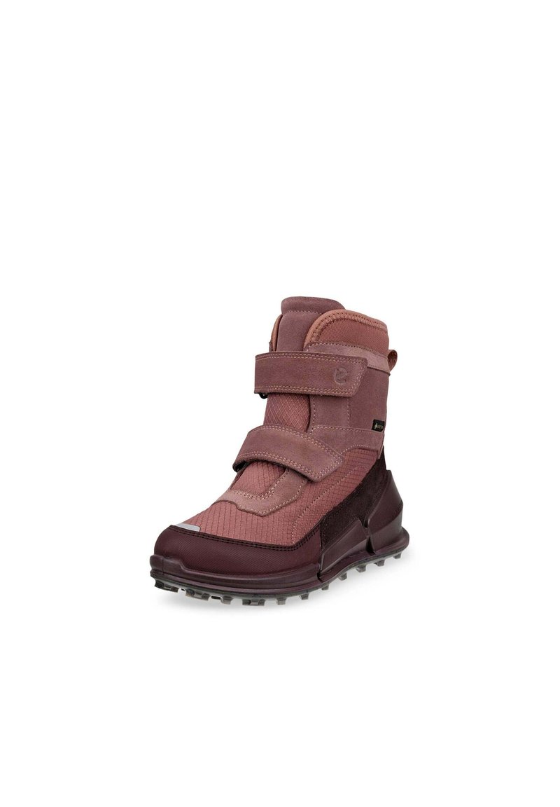 Stivali alla caviglia color bordeaux con una superficie strutturata, caratterizzati da due cinturini in velcro e una suola resistente con piccoli tasselli per una migliore aderenza.
