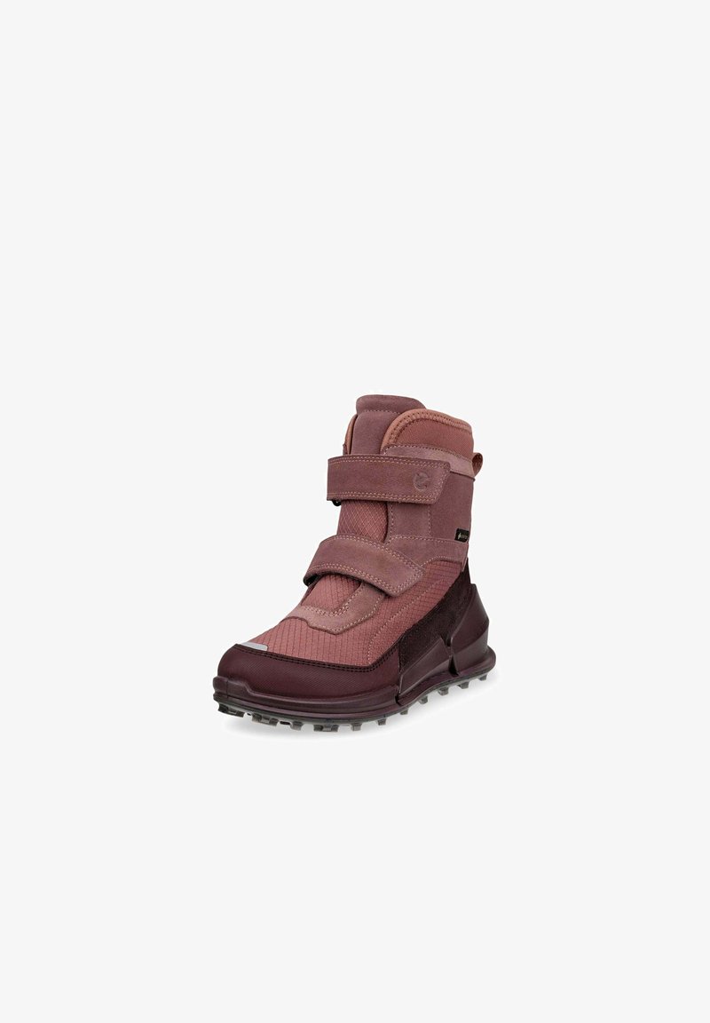 Bordeauxfarbene Stiefel bis zum Knöchel mit einer strukturierten Oberfläche, ausgestattet mit zwei Klettverschlüssen und einer robusten Sohle mit kleinen Profilnoppen für besseren Halt.