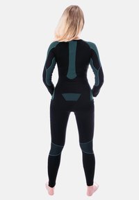 Black full-body wetsuit with green accents. Features long sleeves, fitted design, and textured sections on the back and legs.