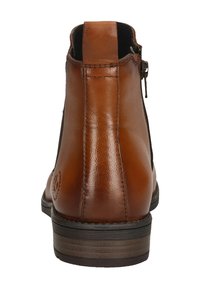 Brown leather ankle boot featuring a side zipper, textured finish, and a stacked heel. Profile shows smooth back with decorative stitching.