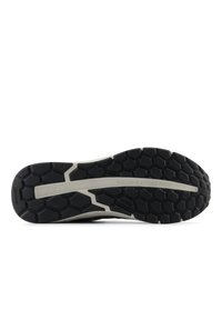 Black and gray athletic shoe sole featuring a hexagonal pattern, prominent "WALKING STRIKE PATH" text, and textured rubber for traction.