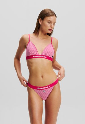 Pink striped bikini set with a triangular bralette and matching thong. Features a logo band in a solid color and soft, sleek material.