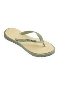 Tongs Havaianas beige et vert clair avec brides et semelle texturées, portant le nom de la marque sur la bride.