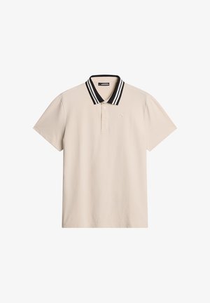 Beige pikétröja med krage i svart och vitt randigt mönster, kort ärm och liten logotyp på bröstet. Mjuk tyg med en klassisk design.