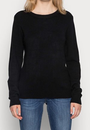 Maglione nero lavorato a maglia con collo rotondo e polsini e orlo a costine. Design semplice, texture morbida e maniche lunghe. Abbinato a jeans blu.