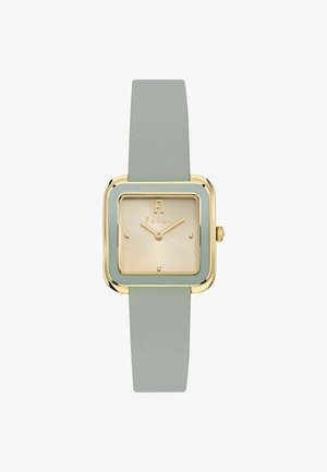 Kvadratna ura z zlatim kovinskim ohišjem in svetlo sivim usnjenim trakcem. Ciferblat je bež z minimalnimi oznakami ur in logotipom blagovne znamke.