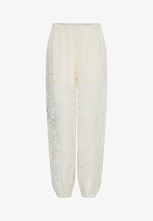 Krémsfarbené čipkované nohavice s elastickým pásom a manžetami pri členkoch, zdobené jemným kvetinovým vzorom.