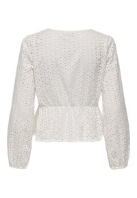 Top bianco a maniche lunghe con design a peplum, realizzato in tessuto traforato con ritagli circolari. Morbida texture con polsini elasticizzati.