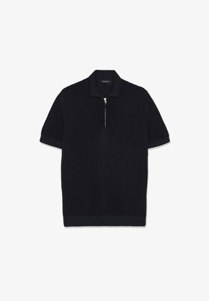 Polo nera a maniche corte con trama testurizzata, colletto e polsini a costine, dotata di chiusura frontale con zip argentata.