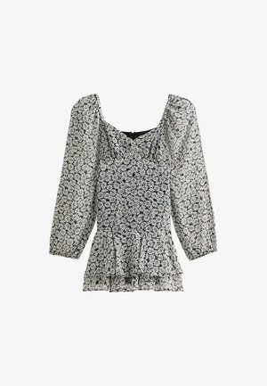 Blusa floral en blanco y negro con mangas abullonadas, dobladillo peplum con volantes y escote redondeado. Tejido ligero con una textura delicada.