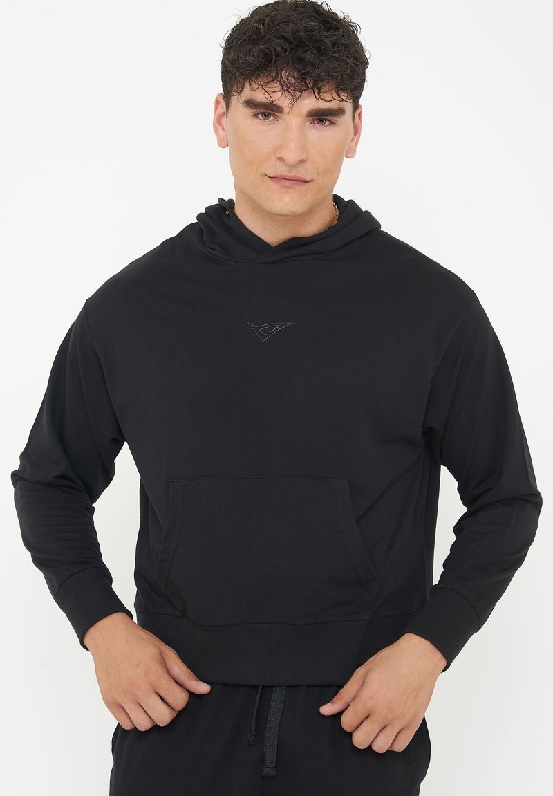 Black hoodie made of soft fabric, featuring a front pocket, hood, and ribbed cuffs. Subtle logo detail stitched on the chest.