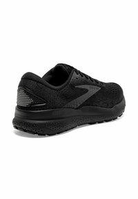 Scarpa da corsa nera con tomaia testurizzata, suola ammortizzata e dettagli riflettenti. Presenta un design stratificato e materiale traspirante.