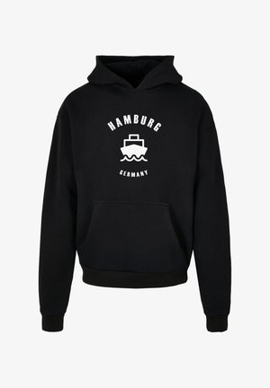 Sweat à capuche noir avec une poche avant, arborant un design graphique blanc d'un bateau et le texte "HAMBURG ALLEMAGNE" imprimé en haut et en bas.