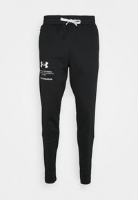 Schwarze sportliche Jogginghosen mit weißen Kordeln und Under Armour-Logo sowie Text auf dem linken Oberschenkel, präsentiert vor einem weißen Hintergrund.