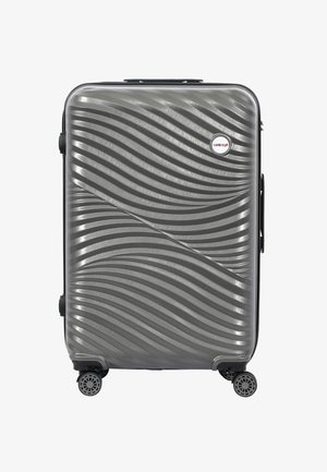 Hard-shell suitcase in textured gray plastic with wave pattern, black zippers, a side handle, and four swivel wheels for mobility.